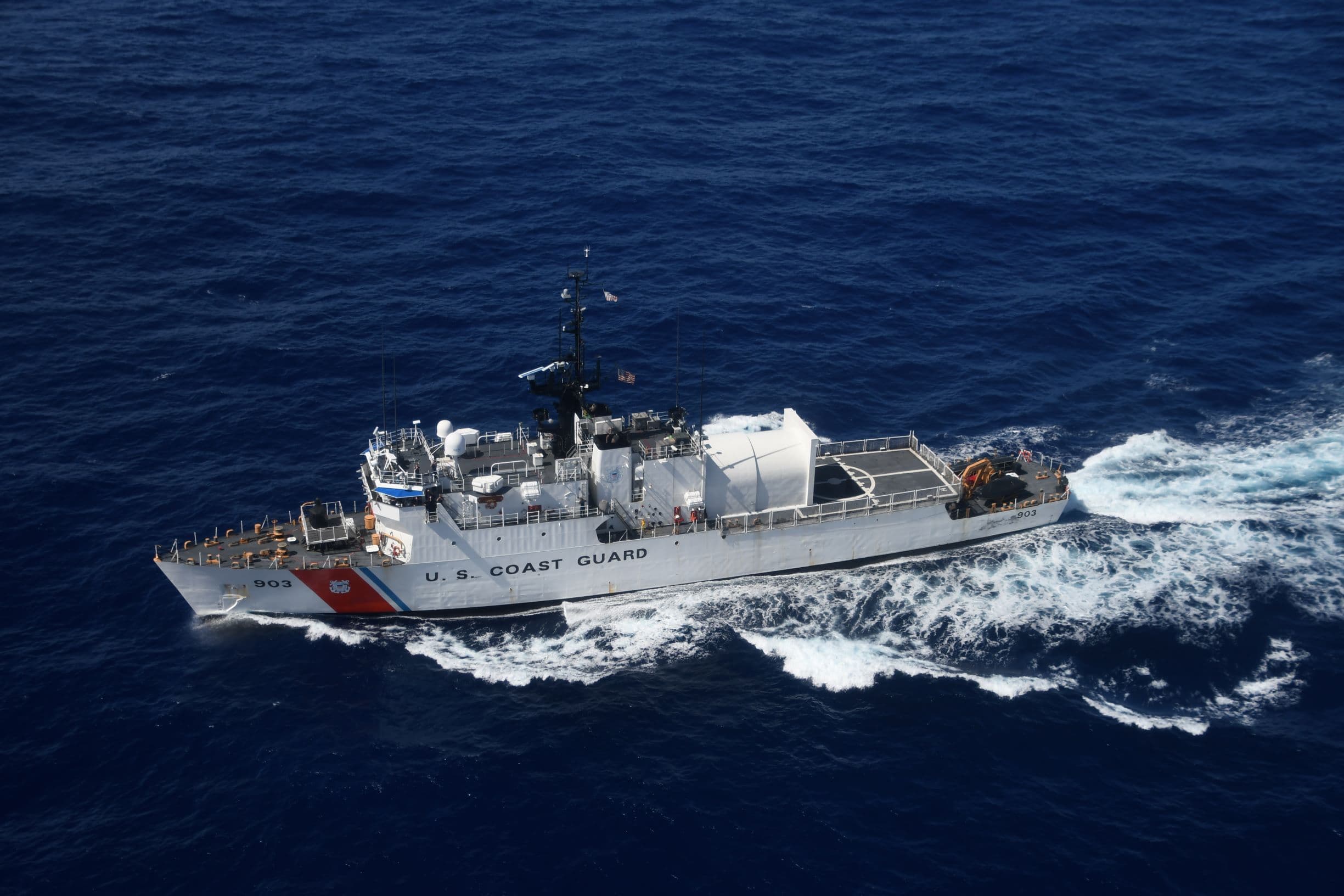 Maritime patrol vessel and surveillance aircraft coordinating at sea